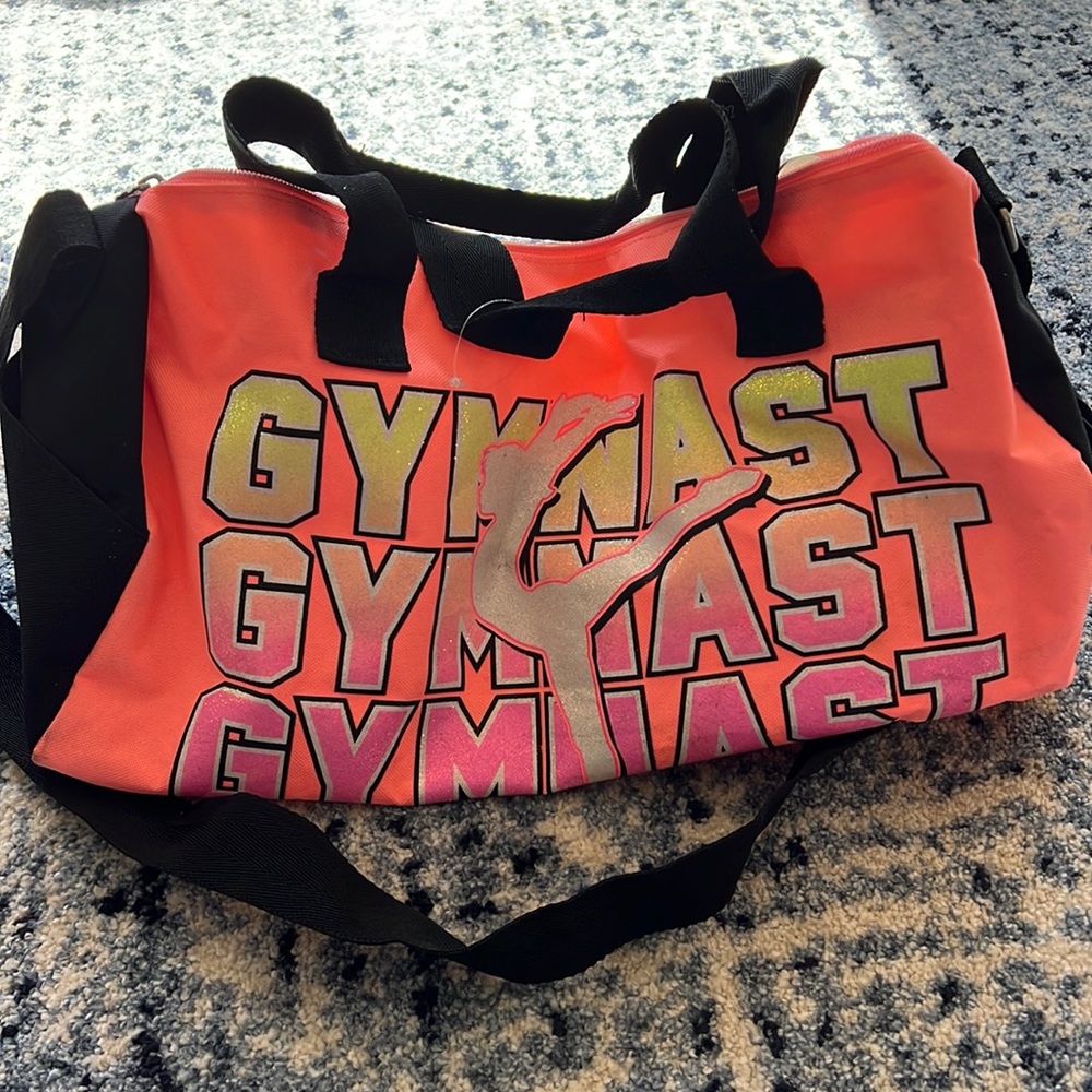 Used Justice Gymnast bag. Markings on the pink from being used.